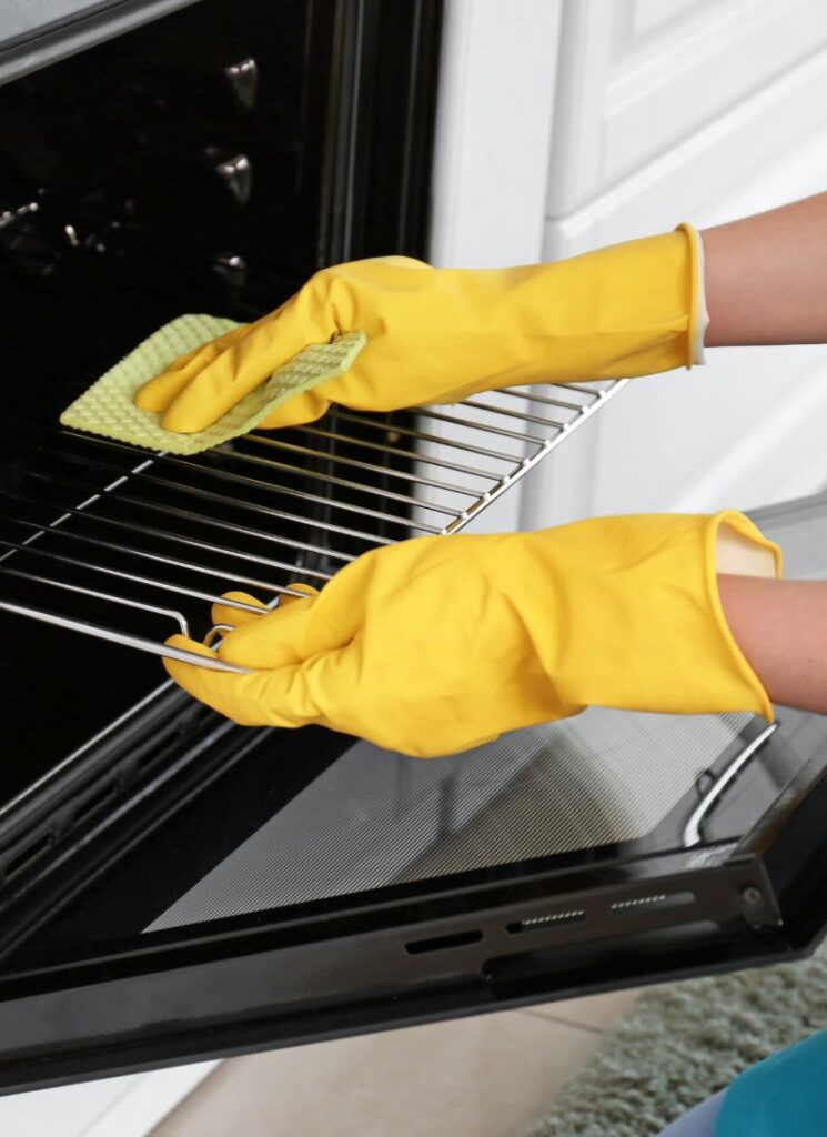 a lady cleaning the oven