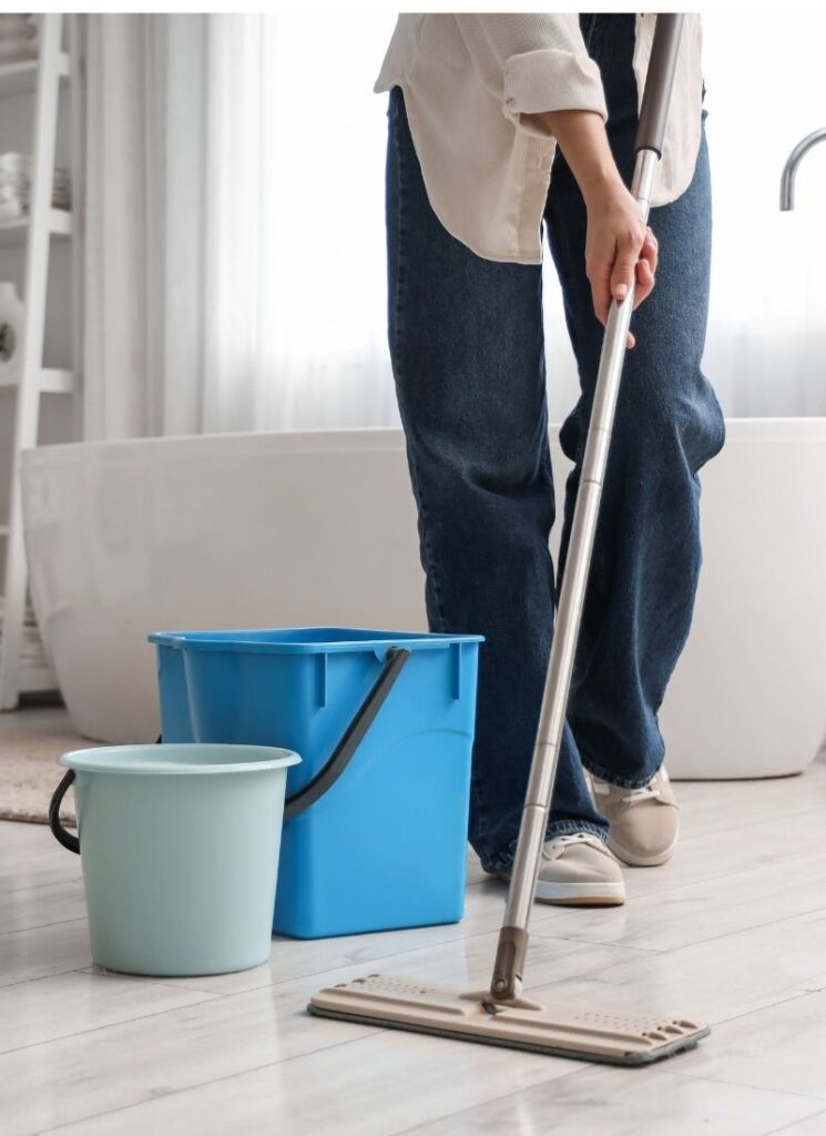 a lady mopping the bathroom floor