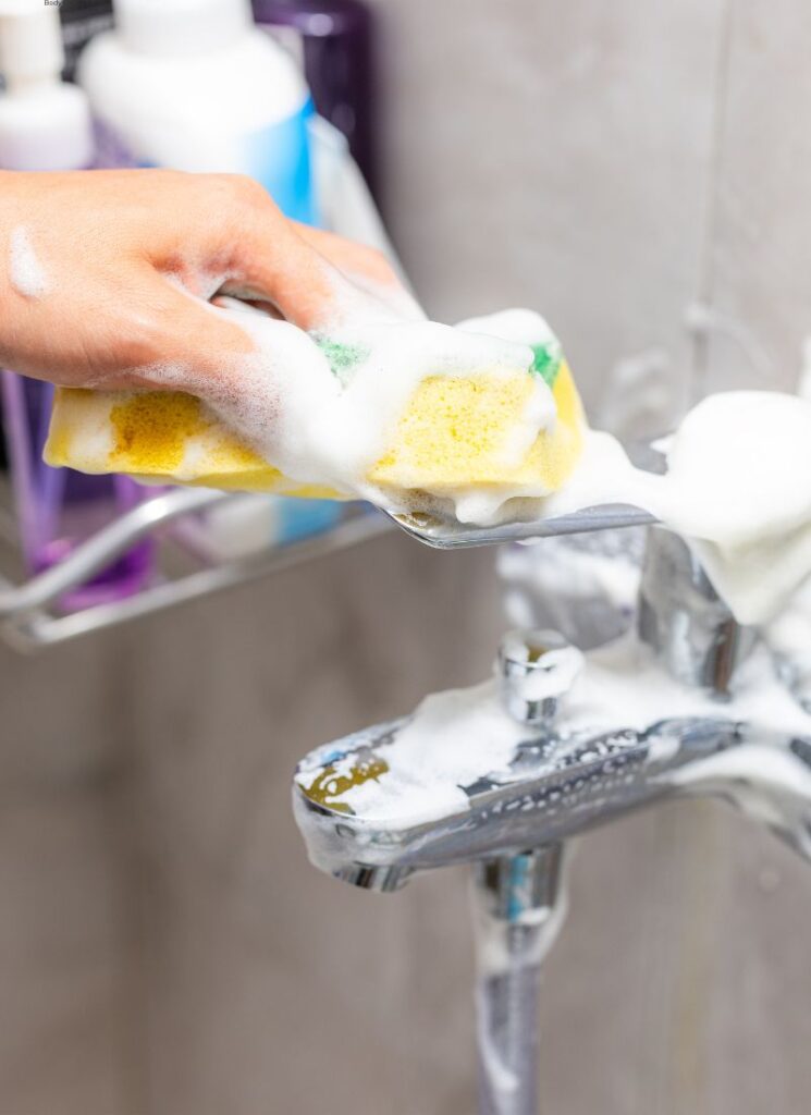 a lady cleaning your faucet
